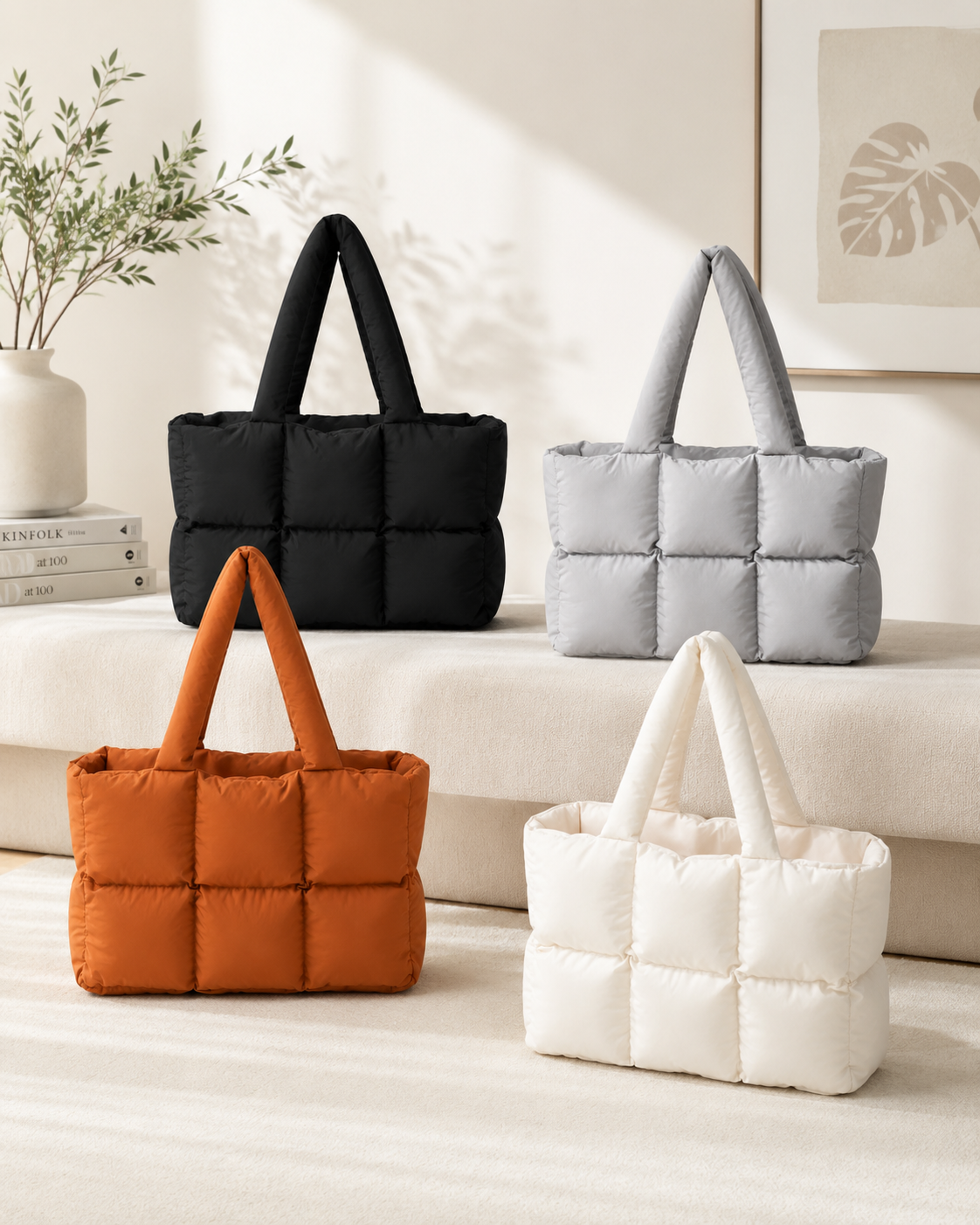 Soft Puffer Tote Bag collection in black, light gray, rust orange, and off-white on cream sofa