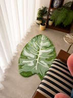 Tufted Plant Rug - monstera leaf-shaped rug on floor in cozy room corner with houseplants