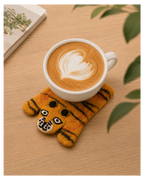 Wool Felt Animal Coaster - tiger-shaped felt coaster in orange and black under latte cup