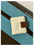 Toast Polaroid Memory Album - cream quilted mini photo album with brown leather tab closure on blue wood surface