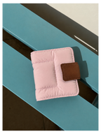 Toast Polaroid Memory Album - light pink quilted mini photo album with brown leather closure on blue wood surface