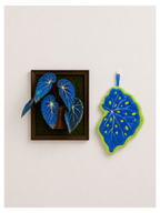 Begonia Leaf Hand Towel - blue felt leaf-shaped hand towel beside framed blue begonia leaf art